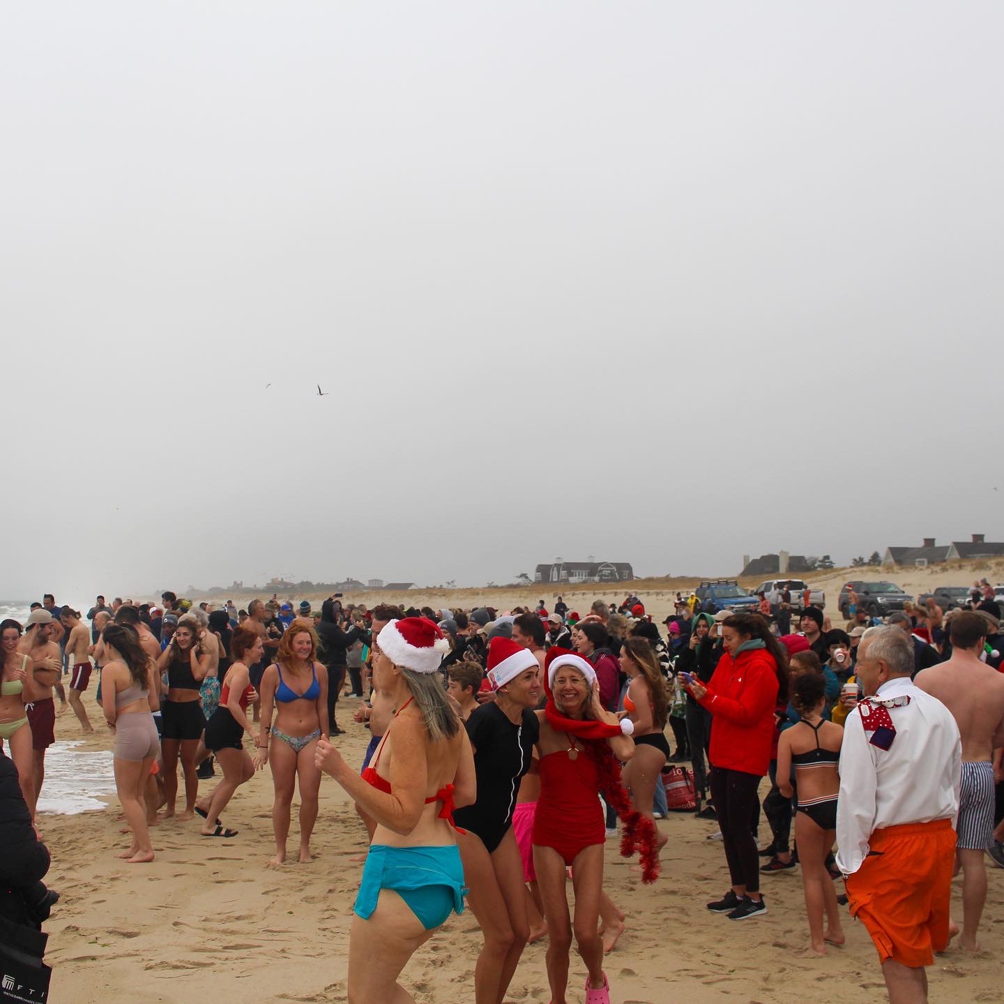 a large group of people mingling at the beach