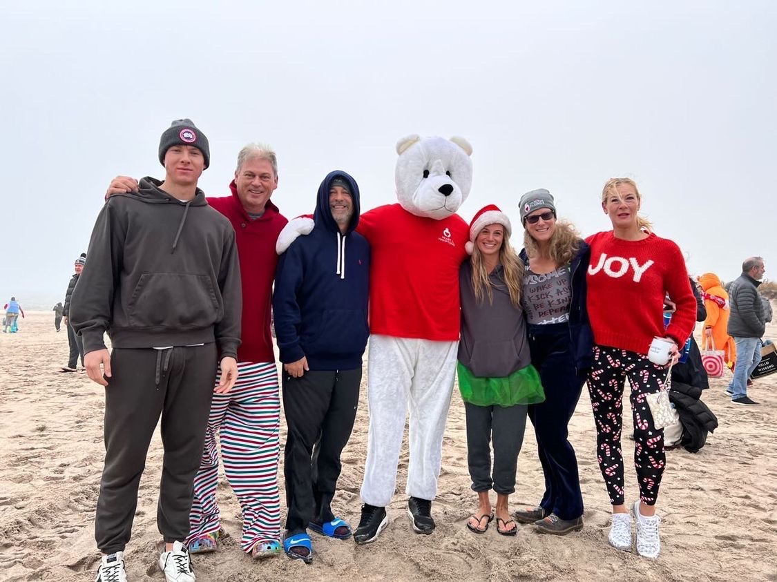 • a group of people and a polar bear mascot