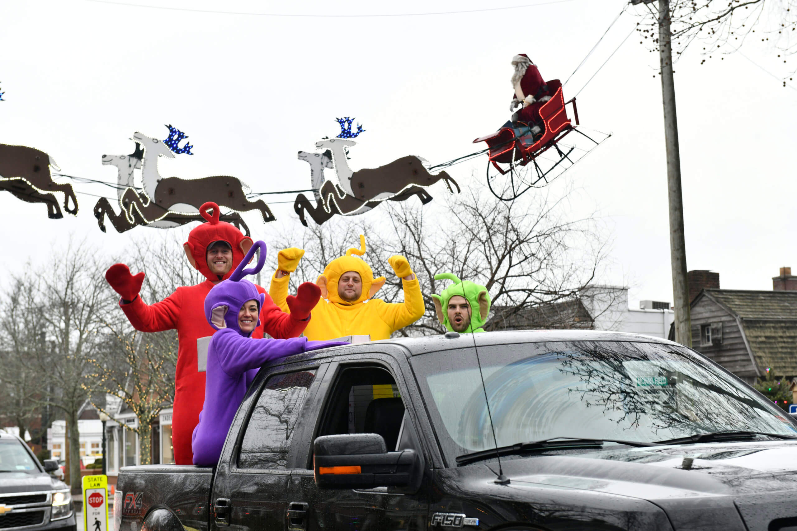 friends in polar bear costumes standing on the car
